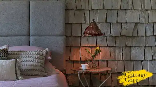 Elegant outdoor wall light fixture on a rustic brick wall.
