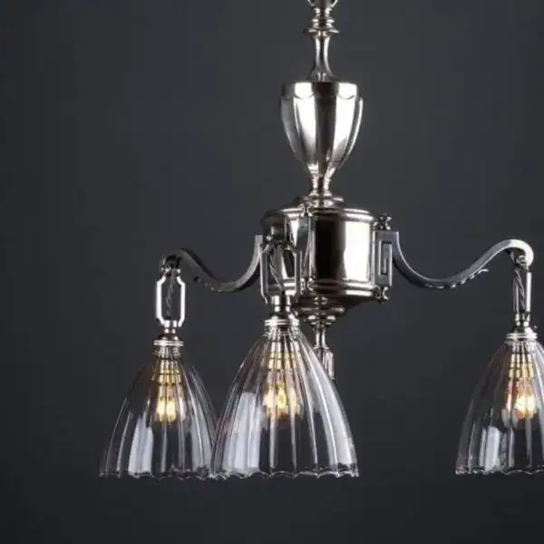 Chandelier with glass shades and metallic finish, ideal for classic interior lighting solutions.
