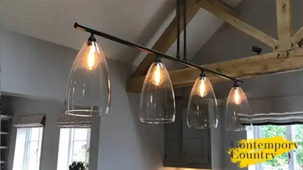 Fritz Fryer Lighting UK - Modern glass pendant lights over kitchen island.