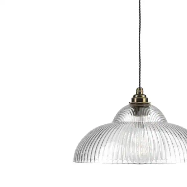 Pendant light with clear ribbed glass shade and brass fitting, ideal for contemporary interiors.