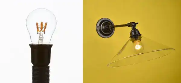 Industrial wall-mounted light with exposed bulb and adjustable arm.