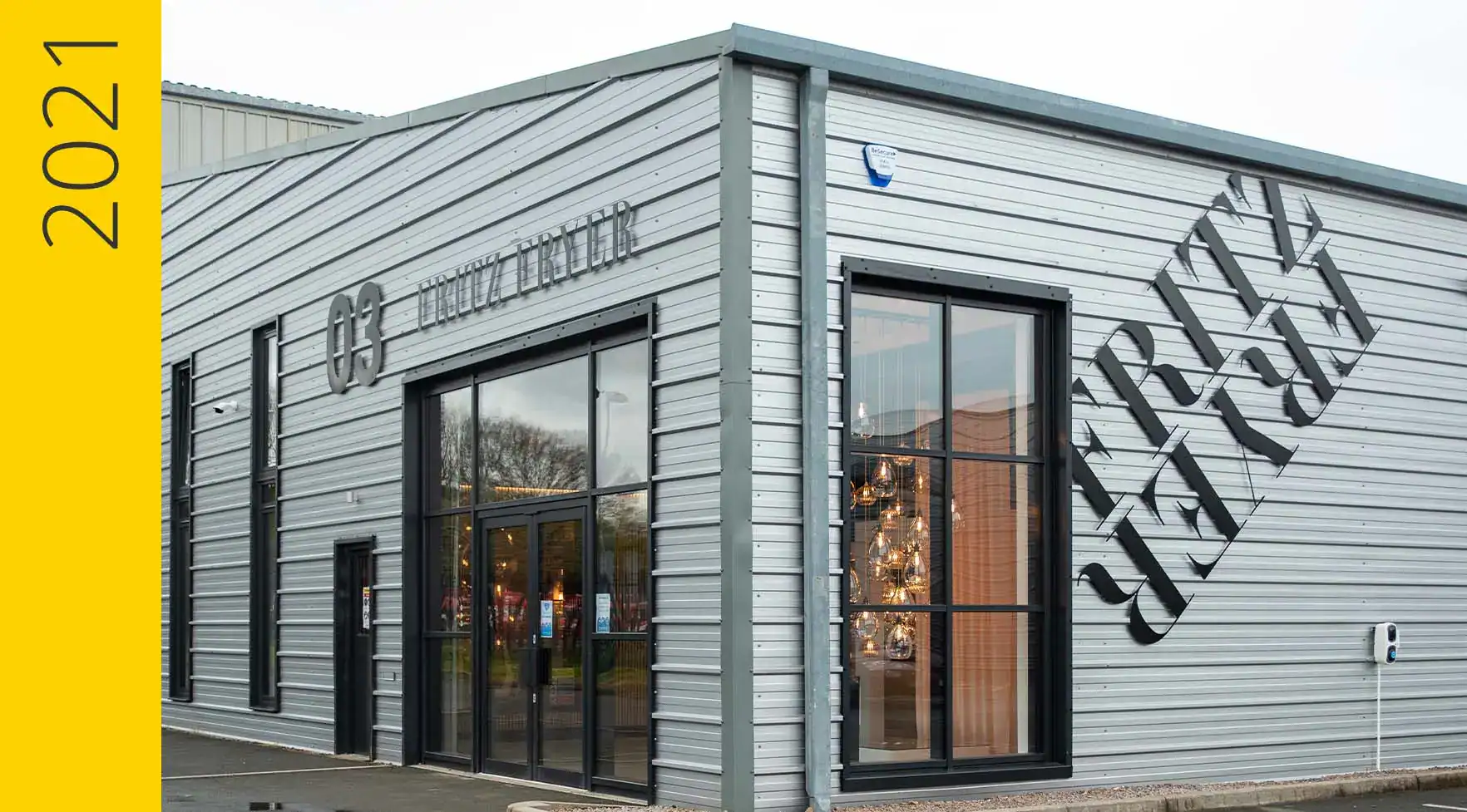 Brightly lit Fritz Fryer lighting showroom with large glass windows and modern exterior design.