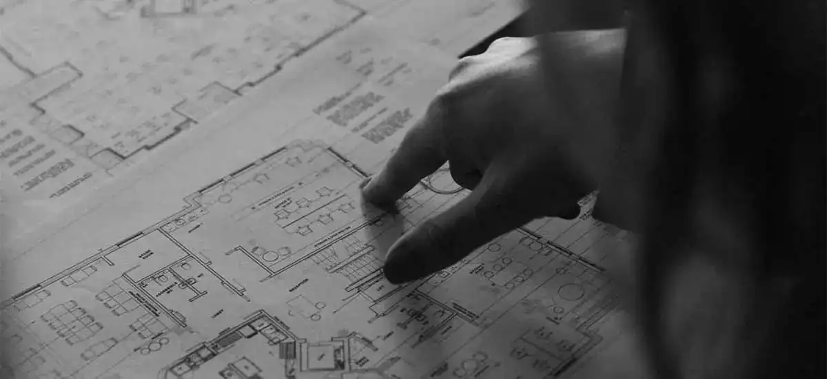 Architectural lighting design plan with hand pointing.