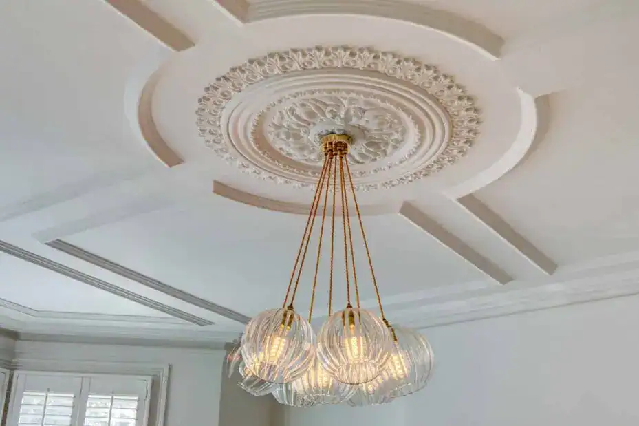 Elegant ceiling chandelier with glass globes and gold accents.