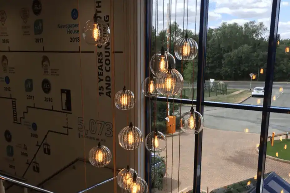 Modern hanging pendant lights with glass globes in a contemporary interior setting.
