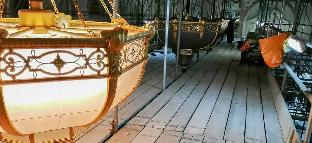 Elegant vintage boat lighting fixtures in a workshop setting.
