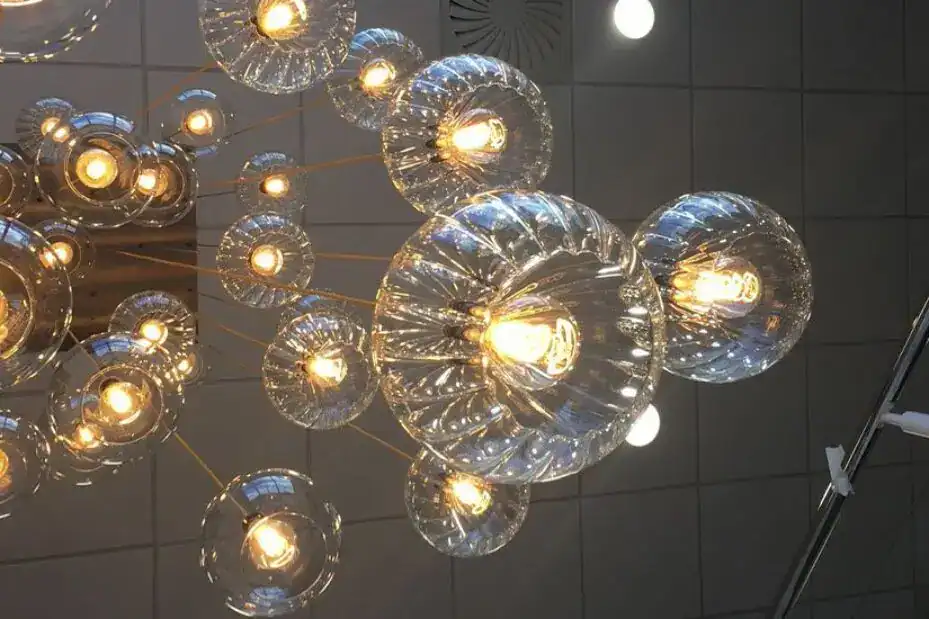 Modern glass pendant light fixture with multiple bulbs.