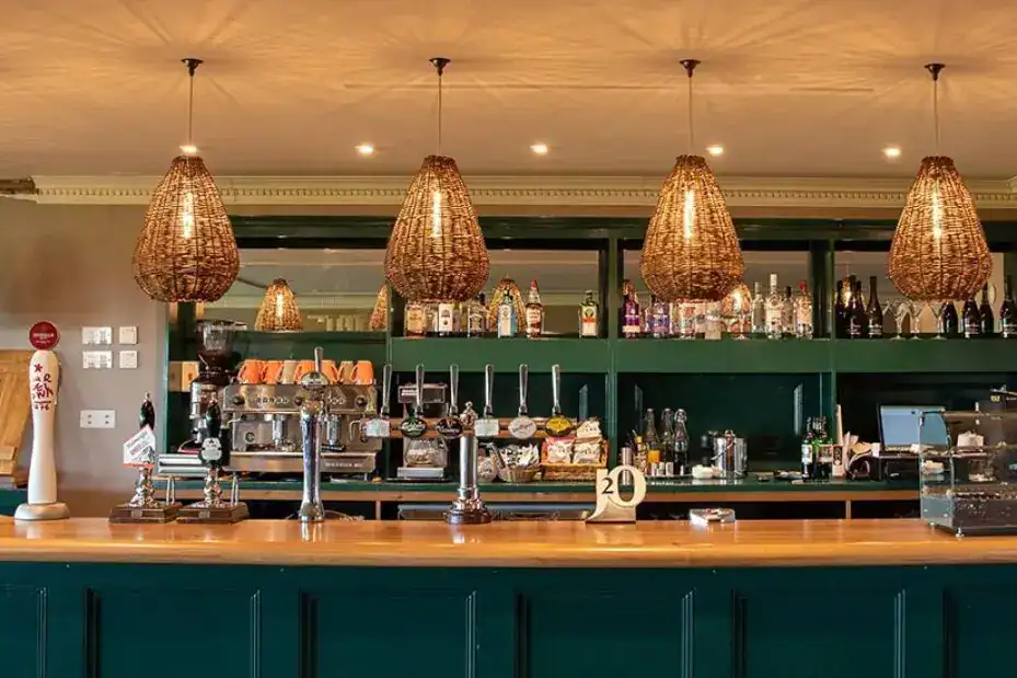 Elegant bar illuminated by hanging pendant lights.