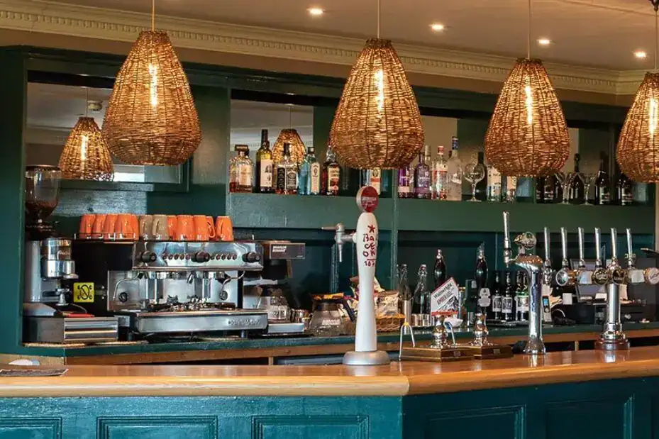 Elegant bar illuminated by warm pendant lights.