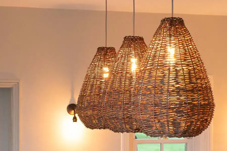 Wicker pendant lights hanging from ceiling with warm glow.