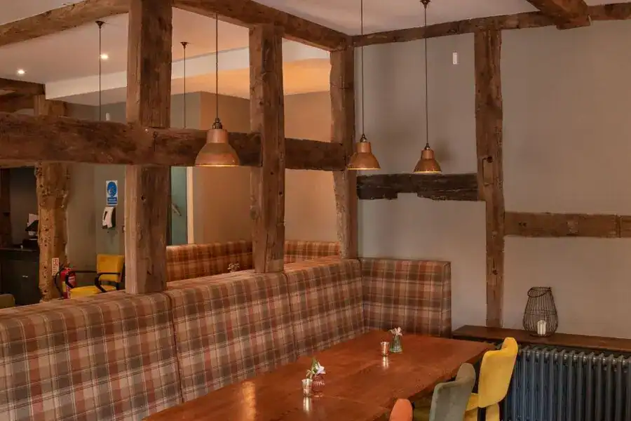 Elegant wooden beam lighting installation in a cosy restaurant.