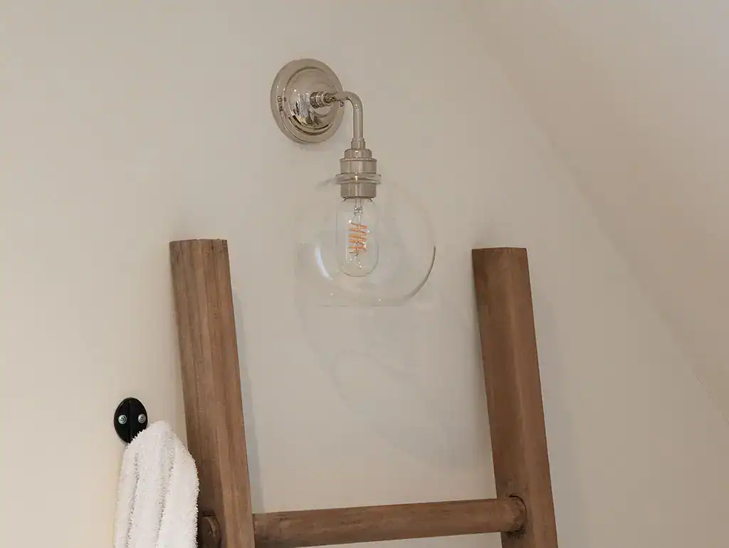 Vintage wall light with exposed filament bulb.