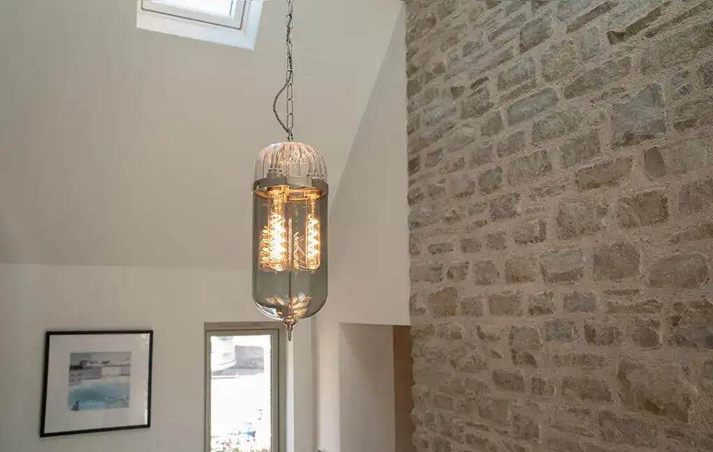 Pendant light with vintage filament bulb in modern interior.