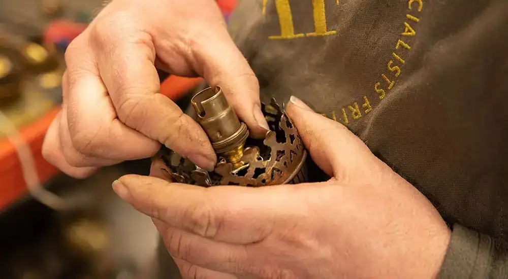 Handcrafting vintage-style light fixtures.