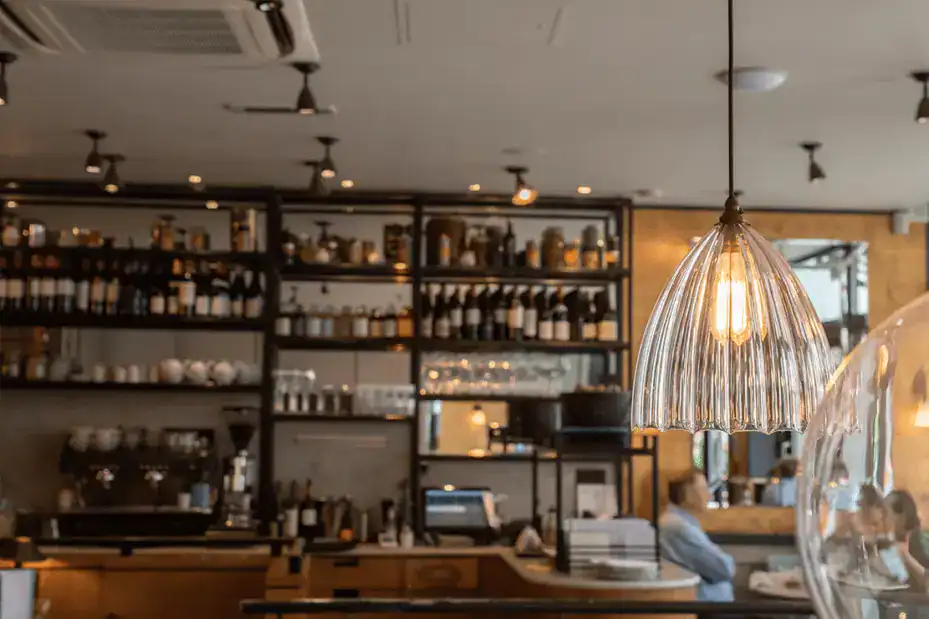Elegant pendant light in a modern café setting.
