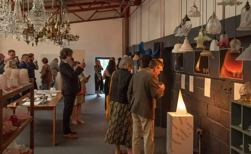 Elegant lighting display at Fritz Fryer Lighting UK showroom with visitors exploring modern and vint.