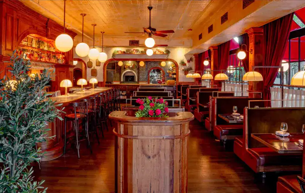 Elegant restaurant interior with warm lighting and wooden furnishings.