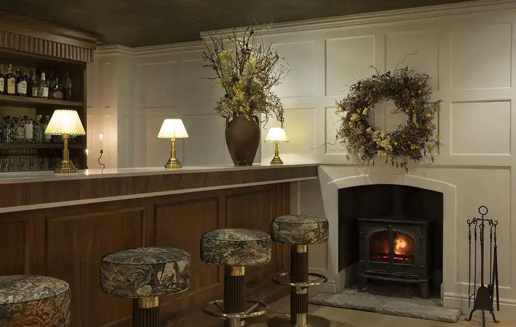 Elegant bar area with warm lighting and decorative wreaths.