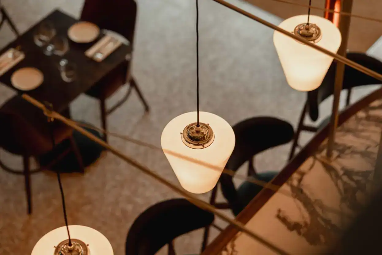 Elegant pendant lighting fixtures in a modern dining setting.