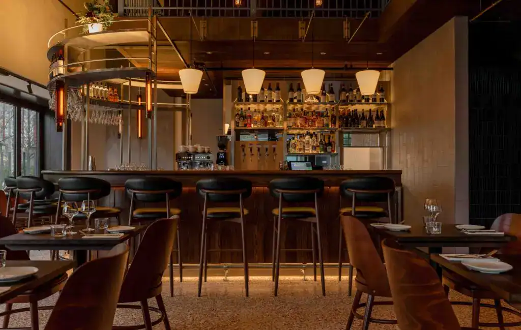Modern bar interior with warm lighting and stylish seating at Fritz Fryer Lighting UK.