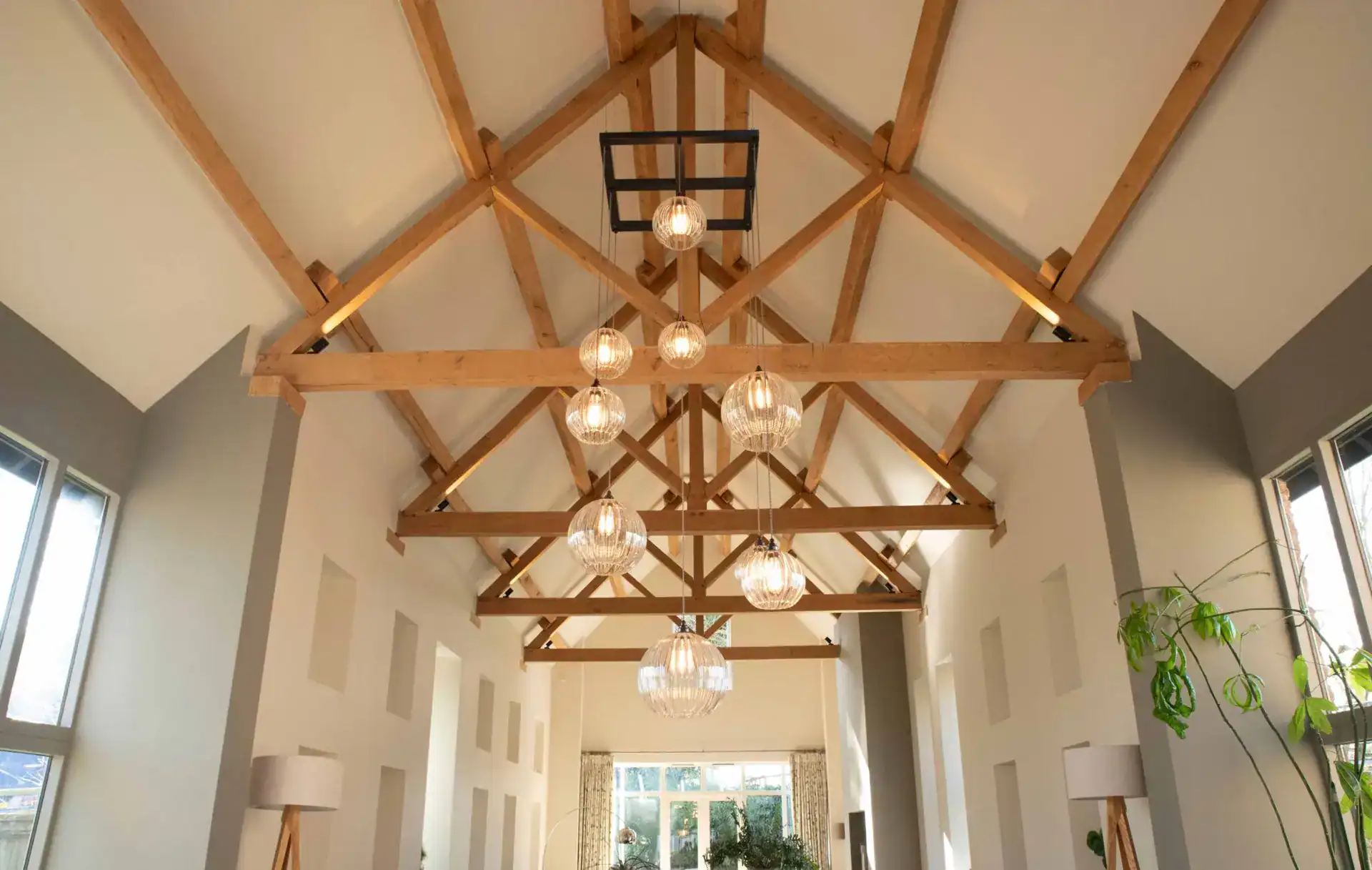 Elegant wooden ceiling with modern pendant lighting fixtures in a contemporary interior design.