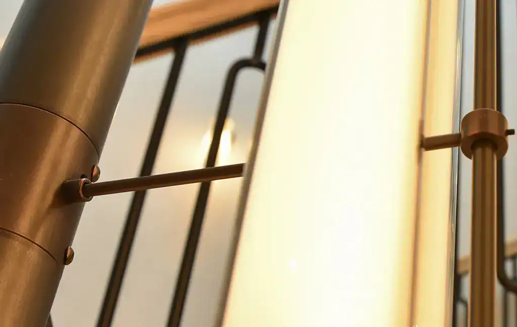 Modern metal wall light fixture with sleek design and warm lighting.