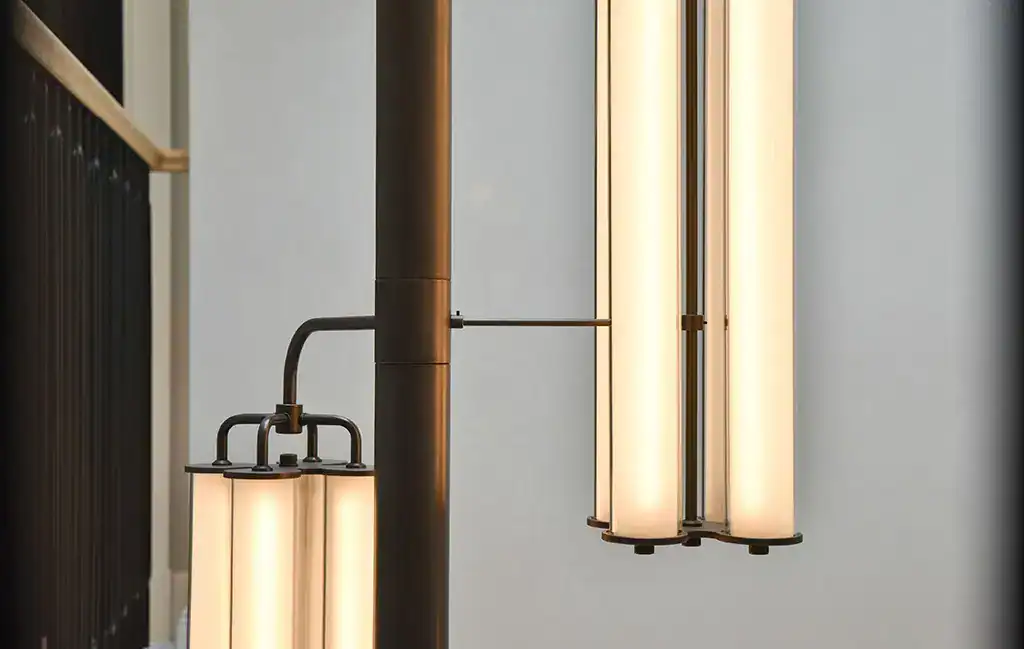Contemporary vertical pendant lights with warm glow, ideal for stylish interior lighting.