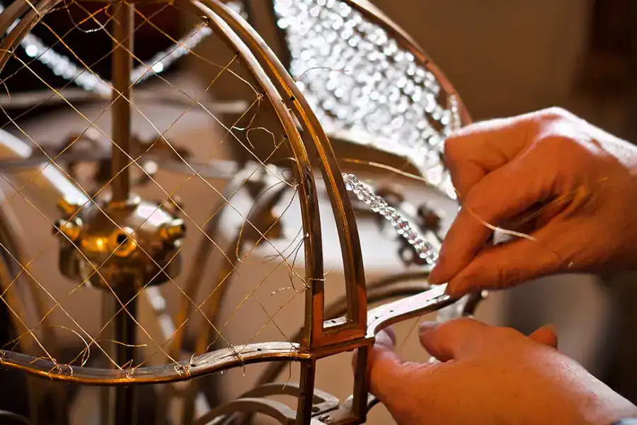 Handcrafted vintage-style lighting fixture being assembled at Fritz Fryer Lighting UK.