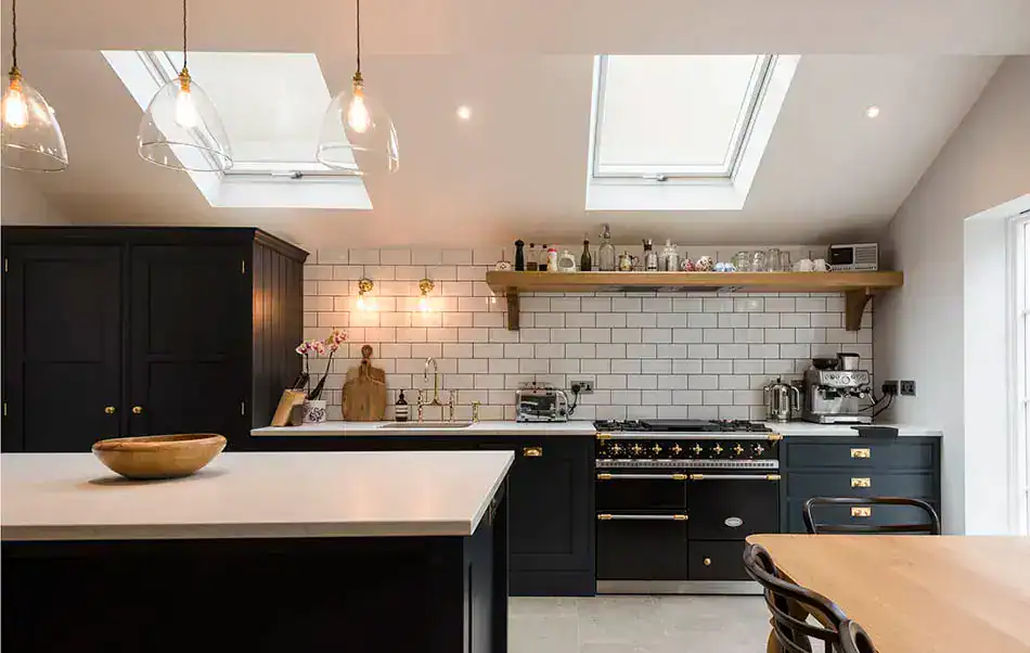 Pendant lighting over kitchen island with modern bulbs and glass shades.