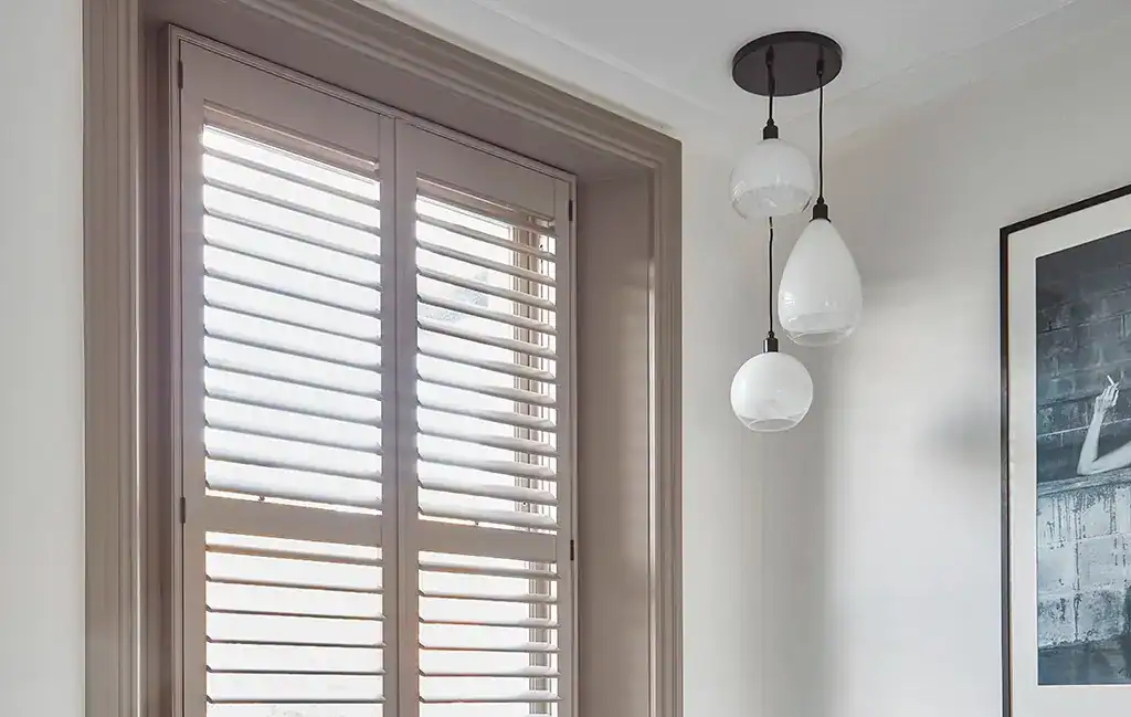 Elegant pendant lighting over window.