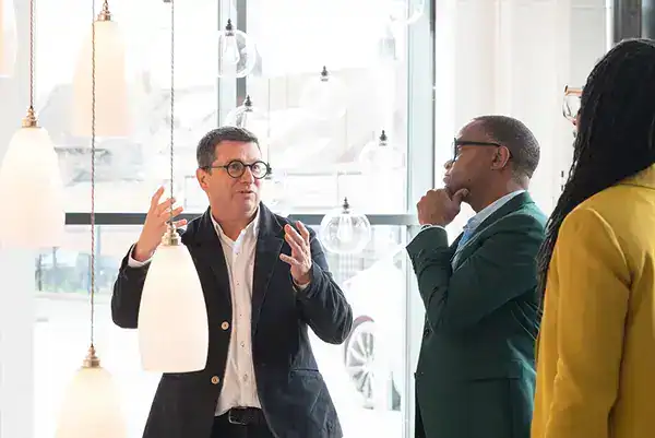 Lighting showroom with professionals discussing modern lighting solutions.
