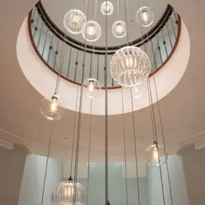 Elegant glass pendant lights hanging from a circular ceiling opening.