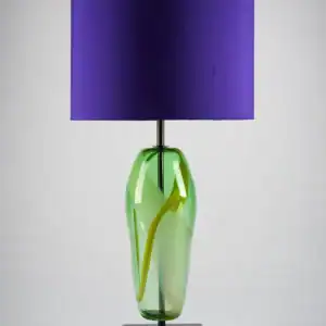 Artisan handblown Lucton table lamp with a vibrant green and yellow glass base and a bold purple lampshade.