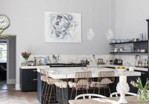 Top Tips For Perfect Kitchen Island Lighting - Three glass pendant lights over a kitchen island in a bright spacious kitchen.