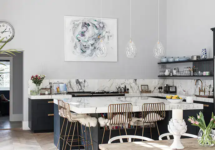 Top Tips For Perfect Kitchen Island Lighting - Three glass pendant lights over a kitchen island in a bright spacious kitchen.