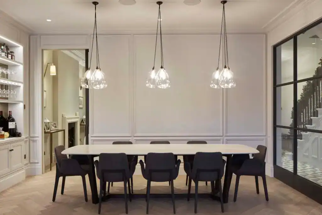 Elegant Wellington cluster pendant lights in clear glass suspended over a modern dining table in a sophisticated dining room.