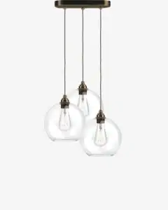 Pendant light with three glass globes and vintage-style bulbs.