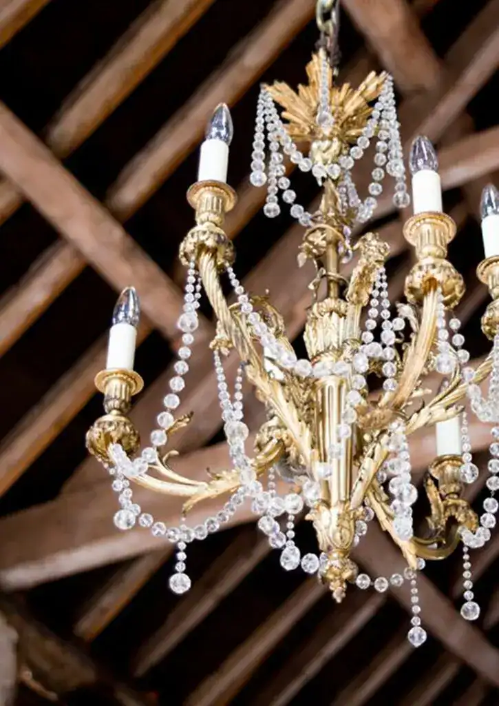 Gold chandelier with crystal beads and candle-style lights.