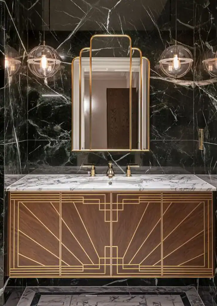 Elegant gold-framed mirror with modern lighting above a marble bathroom vanity.