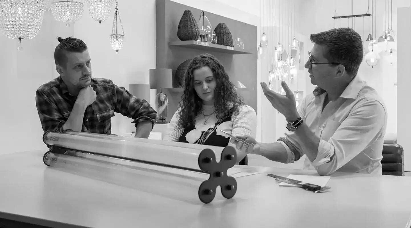 Elegant lighting consultation with three professionals discussing design ideas at a modern office.
