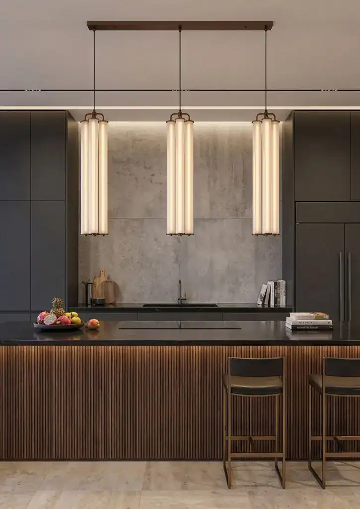 Modern kitchen with vertical pendant lighting and sleek dark cabinetry.