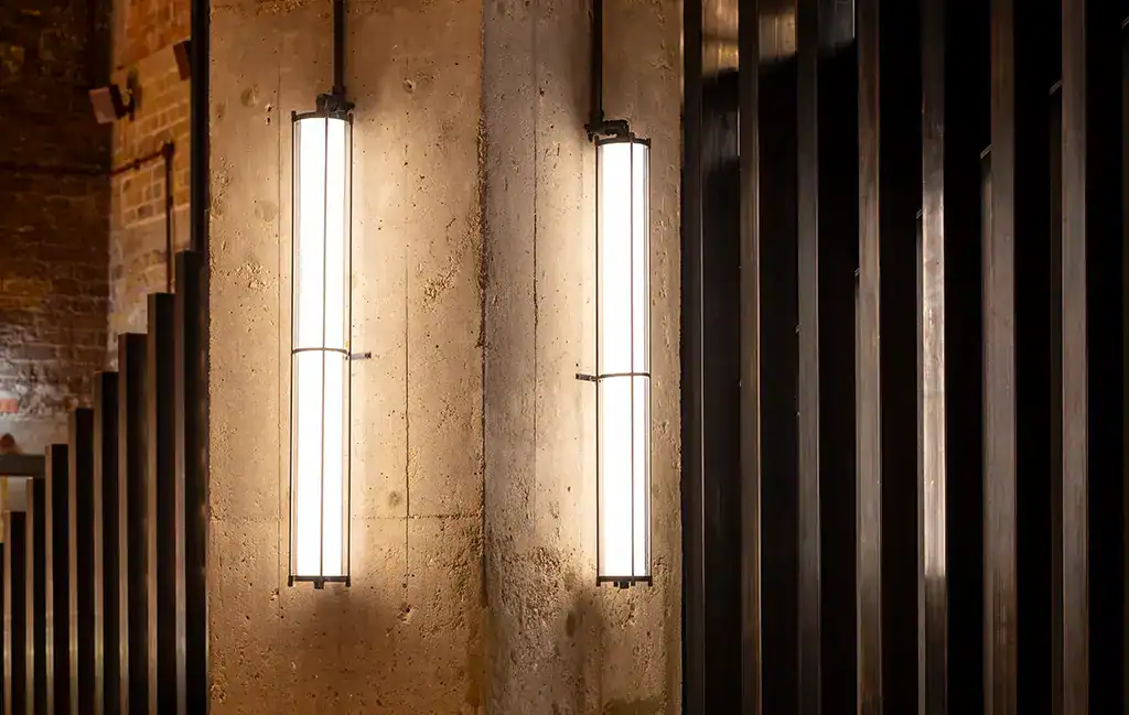 Vertical wall lights with sleek, minimalist design in a contemporary setting.
