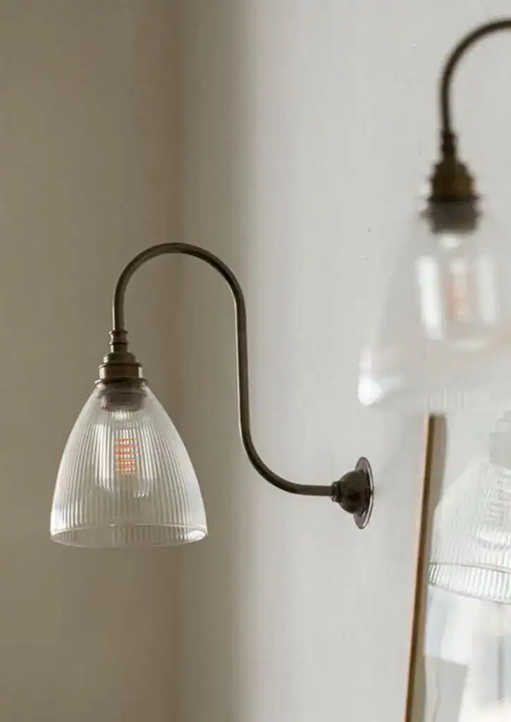 Vintage wall-mounted glass and metal wall light fixture in a modern interior.