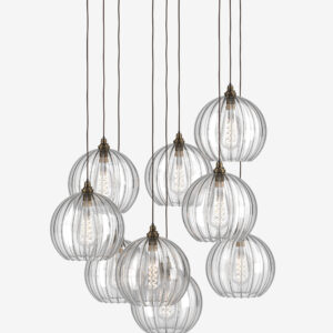 Elegant glass pendant light fixture with multiple spherical lampshades hanging from a white ceiling.