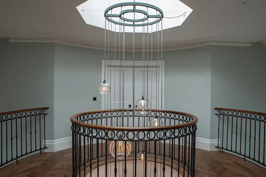 Elegant circular chandelier with hanging bulbs in a modern interior.