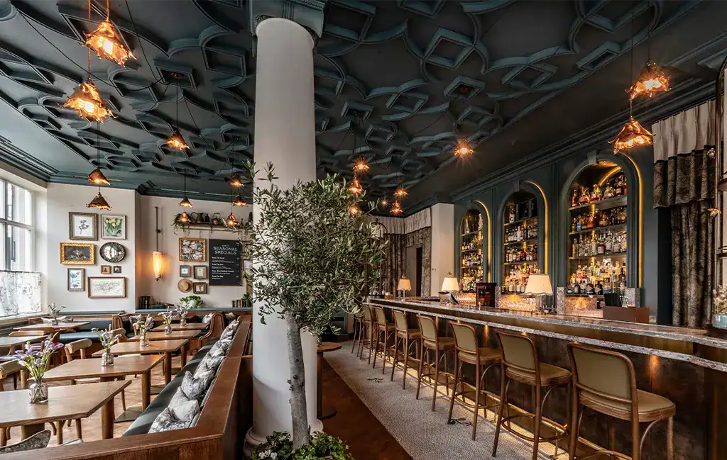 Elegant bar area with stylish lighting and decor at The Cadogan, A Belmond Hotel.
