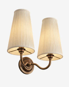 Elegant double arm pleated wall light with pleated fabric shades and antique brass finish.