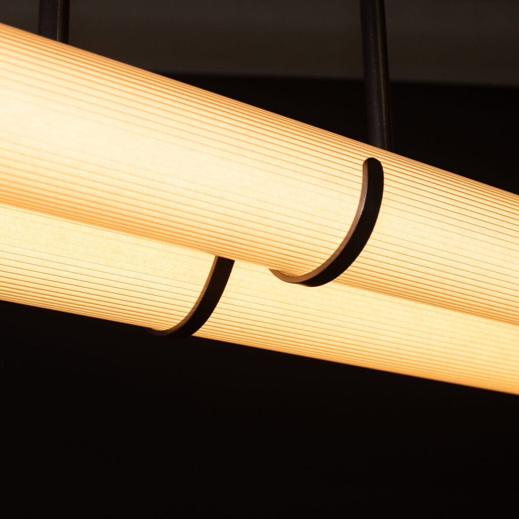 Close-up of a modern pendant light with warm LED illumination.