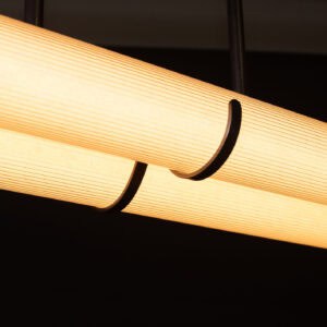 Close-up of a modern pendant light with warm LED illumination.