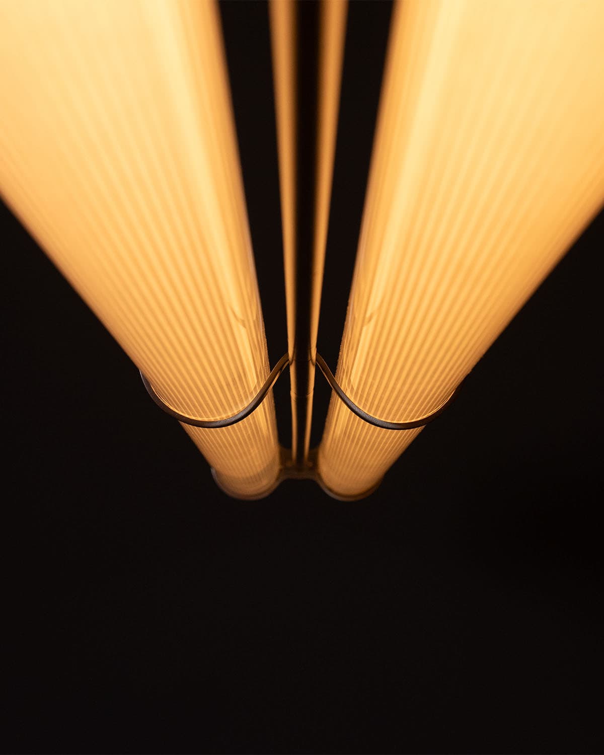 Modern fluorescent lighting fixture with warm glow from below.